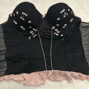 Black and light pink feminine bustier corset with sheer panels and floral lace